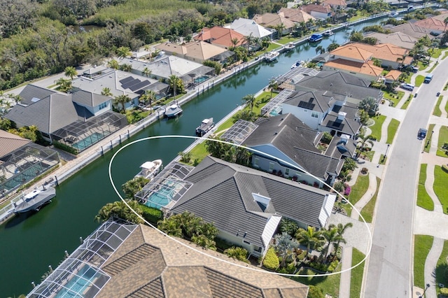 birds eye view of property with a residential view and a water view