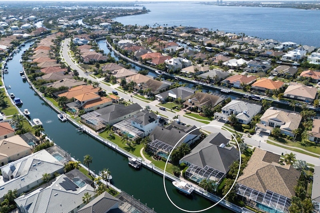 drone / aerial view with a water view and a residential view