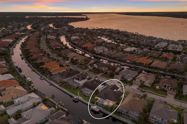 drone / aerial view with a water view and a residential view