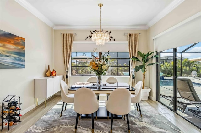 dining space with ornamental molding, plenty of natural light, and wood finished floors