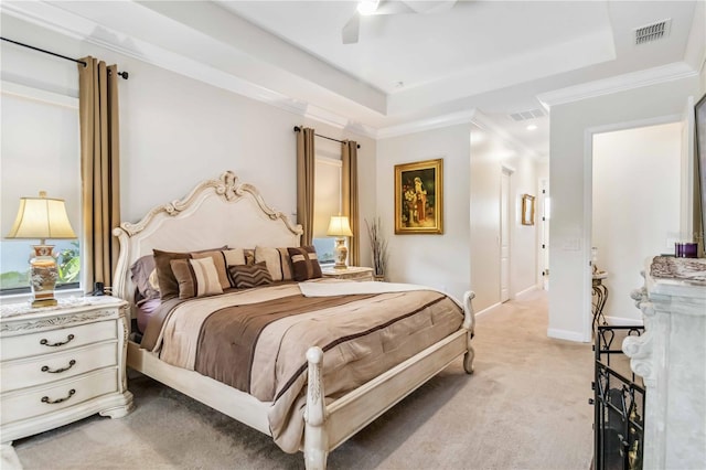 bedroom featuring light carpet, visible vents, and a raised ceiling