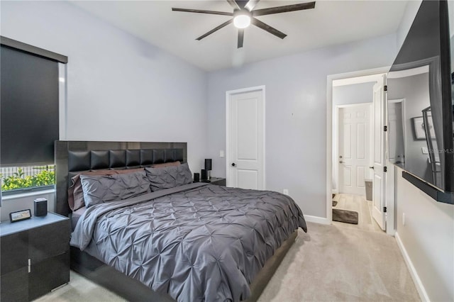 carpeted bedroom with ceiling fan, baseboards, and ensuite bathroom