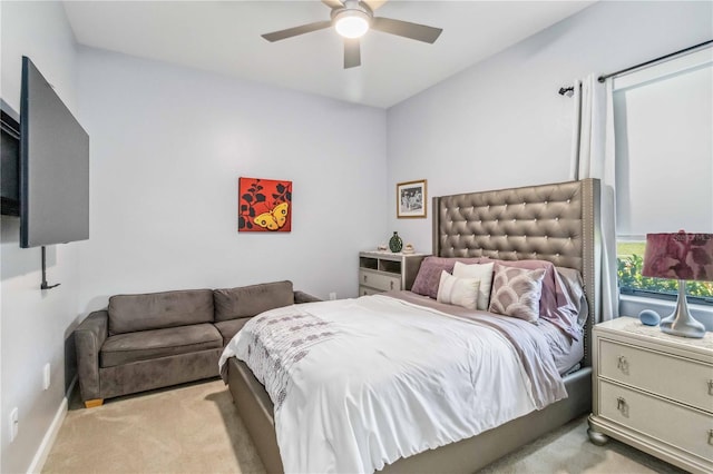 bedroom with light carpet, ceiling fan, and baseboards