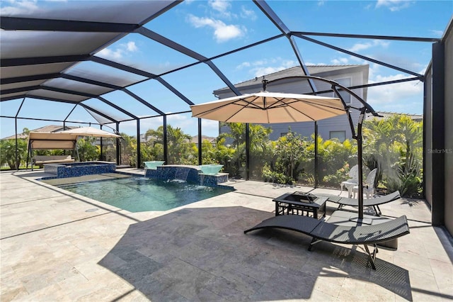 view of pool featuring a patio area, a pool with connected hot tub, and glass enclosure