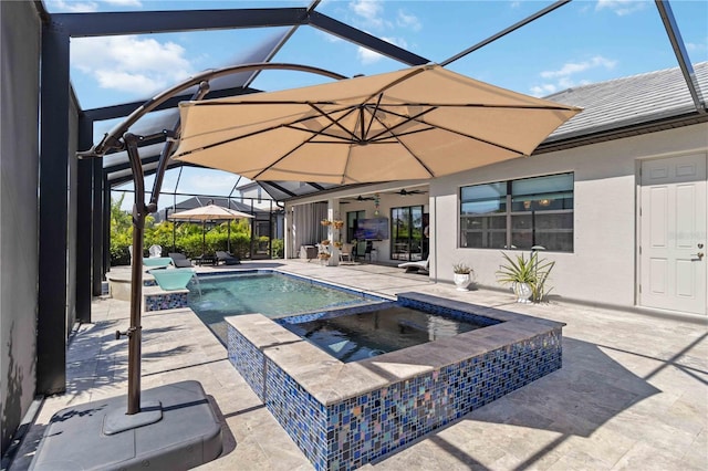 view of swimming pool featuring a lanai, a patio area, and a pool with connected hot tub