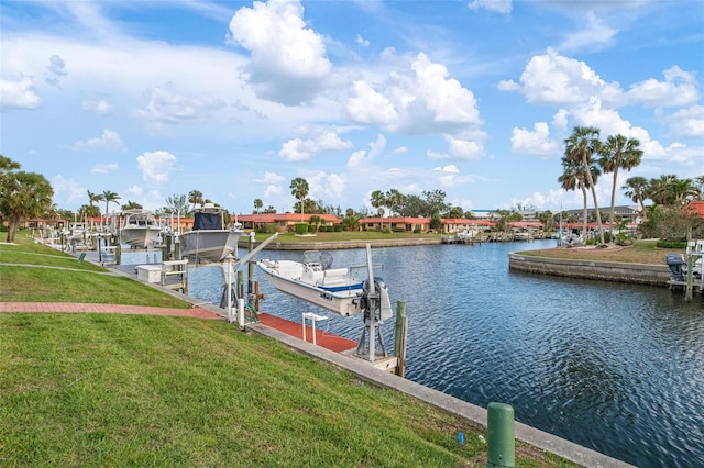 view of dock featuring a lawn, a water view, and boat lift