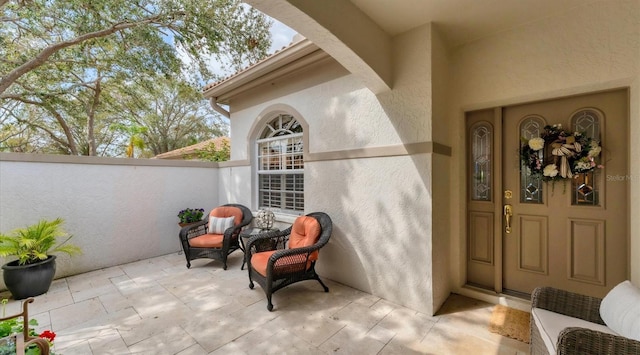 doorway to property featuring stucco siding