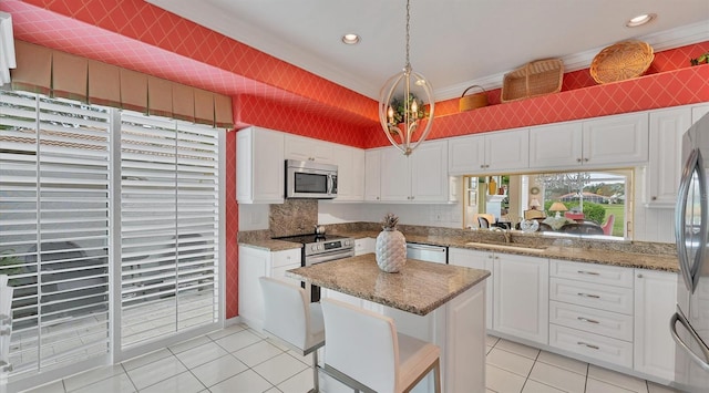 kitchen featuring appliances with stainless steel finishes, a sink, and white cabinetry