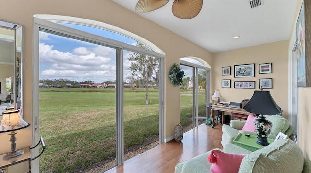 sunroom / solarium with visible vents and ceiling fan