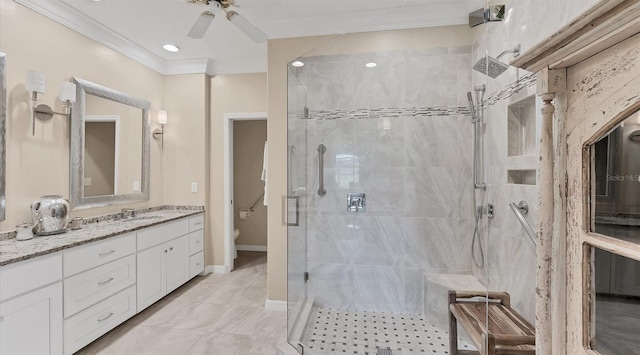 bathroom featuring toilet, vanity, baseboards, ornamental molding, and a stall shower