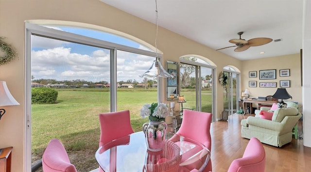 dining space with visible vents, ceiling fan, and wood finished floors