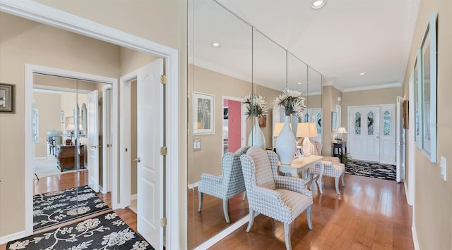 hall with baseboards, ornamental molding, wood finished floors, and recessed lighting