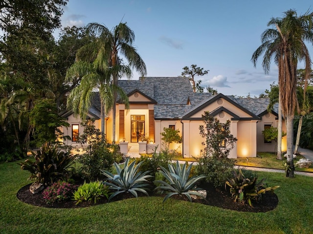 view of front of house featuring a front lawn and stucco siding