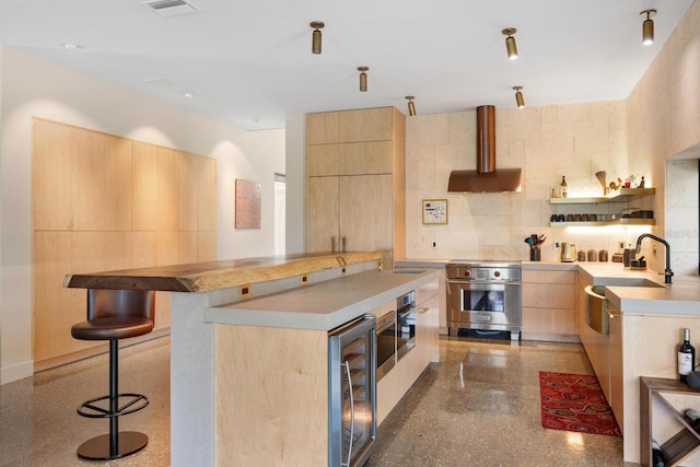 kitchen featuring extractor fan, light brown cabinets, designer stove, beverage cooler, and modern cabinets