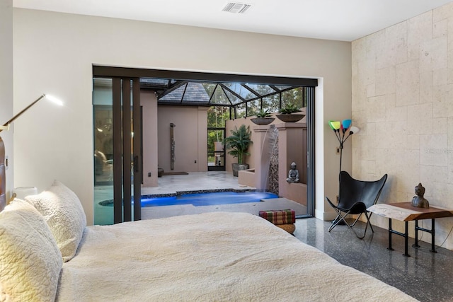 bedroom with speckled floor, visible vents, and concrete block wall