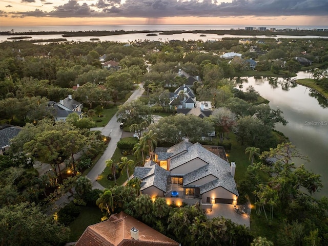 aerial view at dusk with a water view