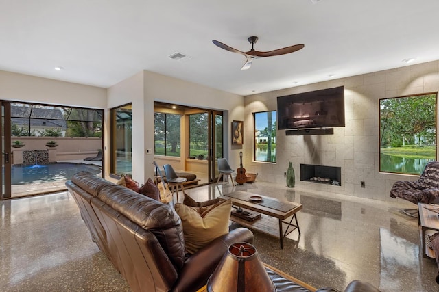 living area featuring ceiling fan, a fireplace, visible vents, and recessed lighting