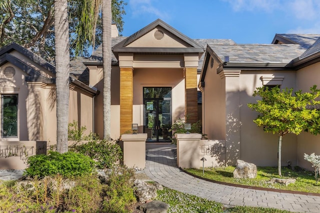 doorway to property featuring stucco siding