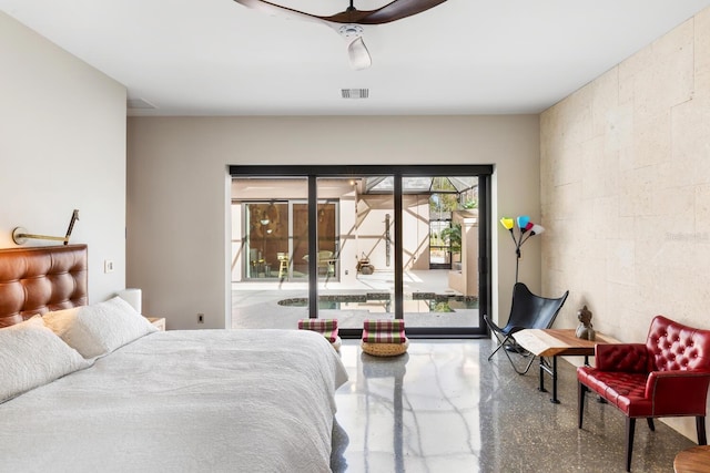 bedroom with visible vents, a ceiling fan, concrete block wall, and access to exterior