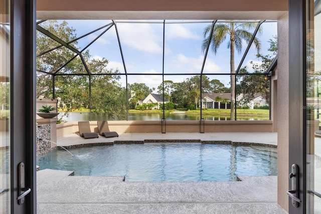 view of swimming pool featuring a lanai and a patio