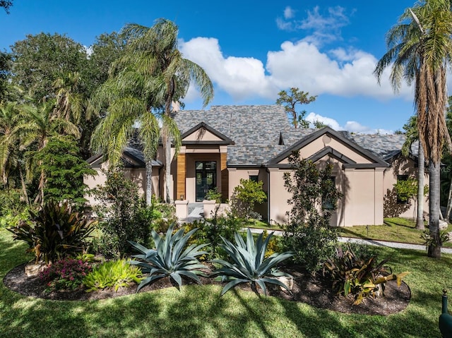 view of front of house featuring a front yard and stucco siding