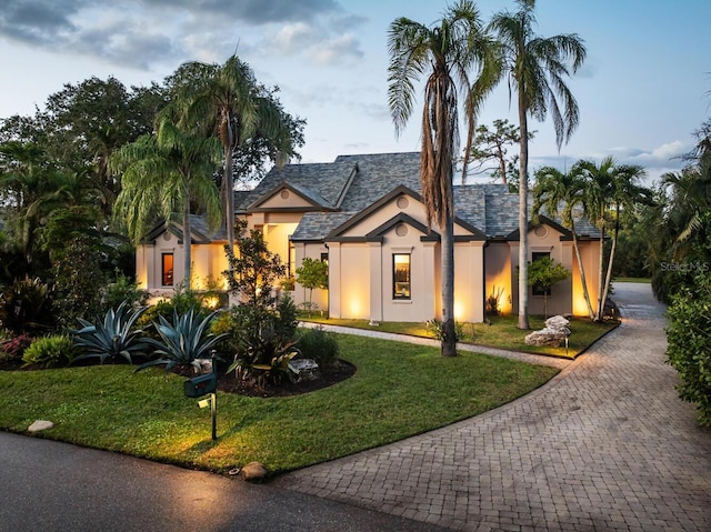 view of front of home with a front lawn and stucco siding