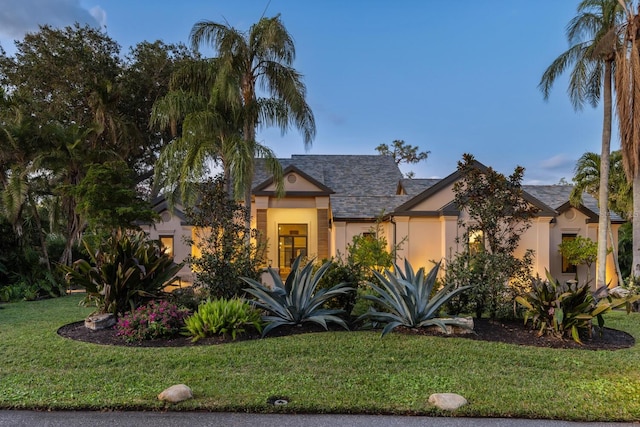 view of front of property with a front yard and stucco siding