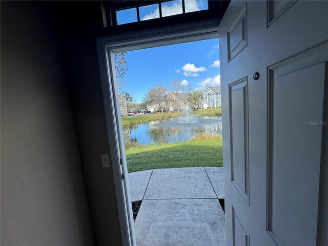 entryway featuring a wealth of natural light and a water view