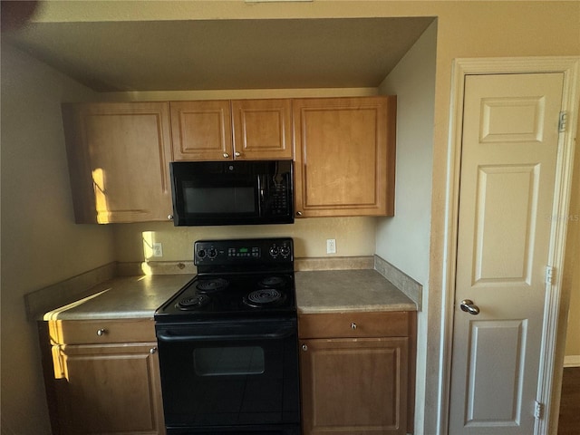 kitchen featuring light countertops, brown cabinets, and black appliances