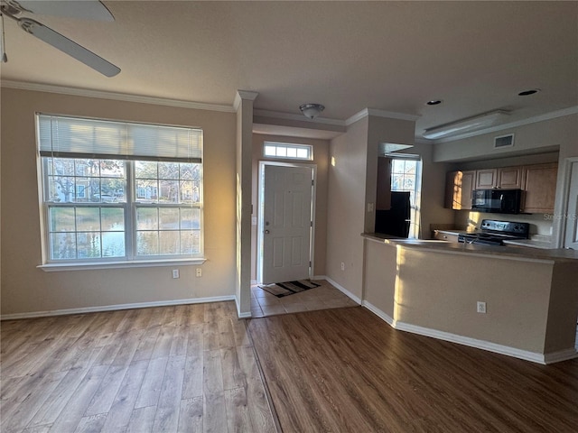 entrance foyer featuring visible vents, ornamental molding, a ceiling fan, wood finished floors, and baseboards