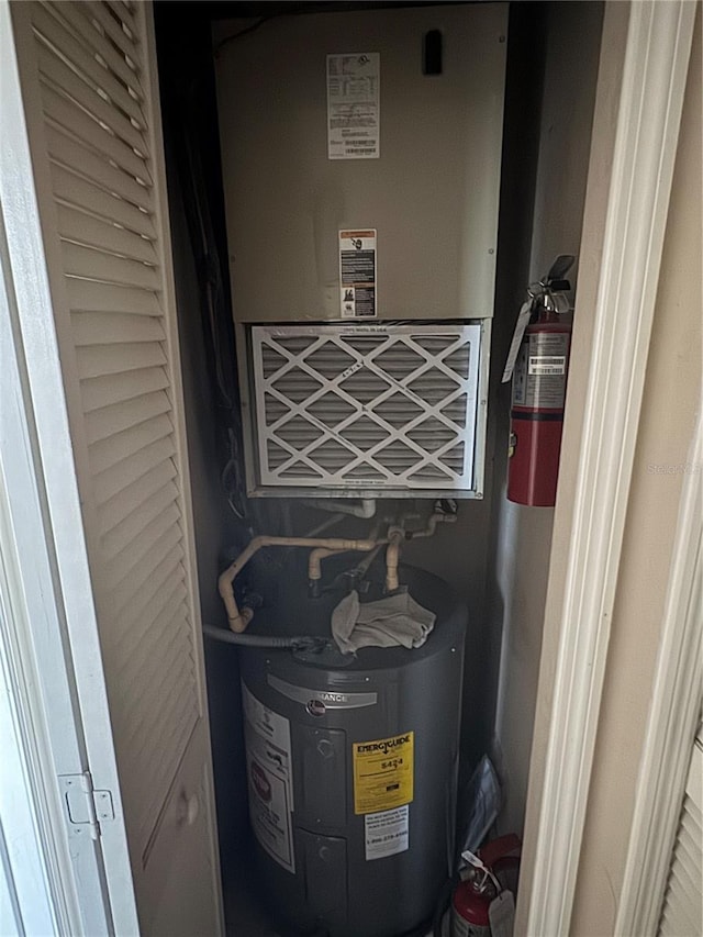 utility room featuring water heater