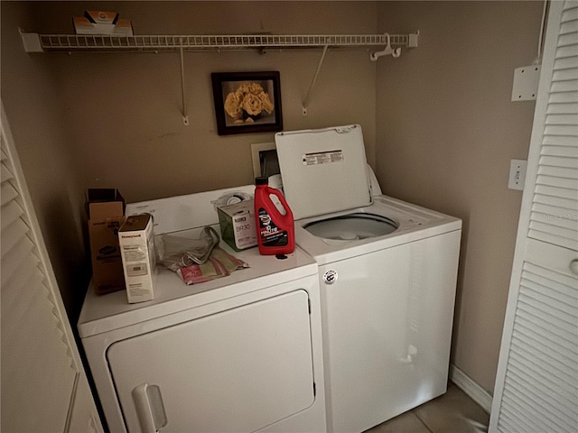 clothes washing area featuring laundry area and washing machine and clothes dryer