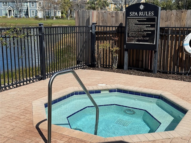 view of pool with a community hot tub and fence