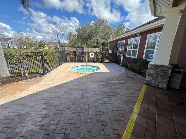 view of swimming pool featuring a patio, a fenced backyard, a gate, and a hot tub