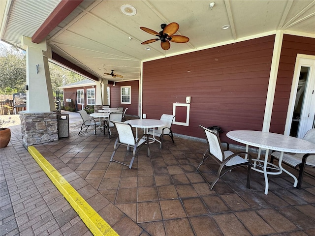 view of patio with outdoor dining space and ceiling fan