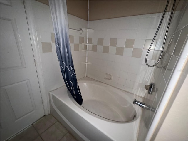 bathroom with shower / tub combo with curtain and tile patterned floors