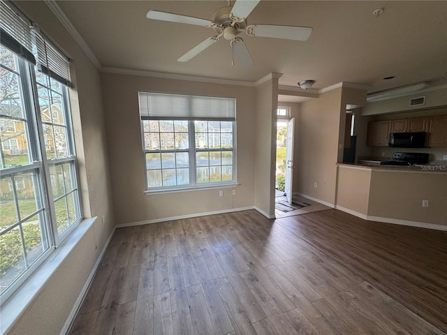 unfurnished living room with ornamental molding, wood finished floors, visible vents, and baseboards