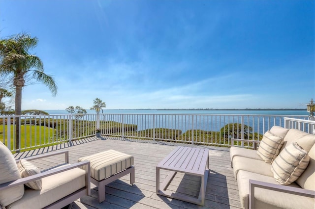 wooden terrace featuring an outdoor hangout area and a water view