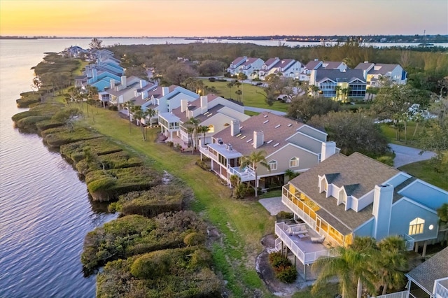 drone / aerial view featuring a water view and a residential view