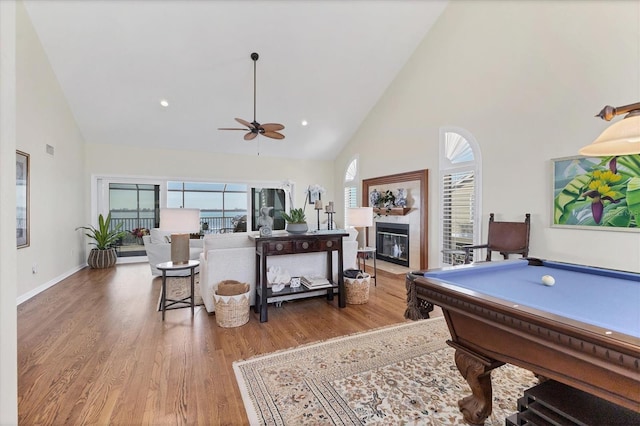 rec room with a fireplace with flush hearth, plenty of natural light, and wood finished floors