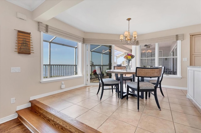 dining room featuring light tile patterned floors, an inviting chandelier, and baseboards