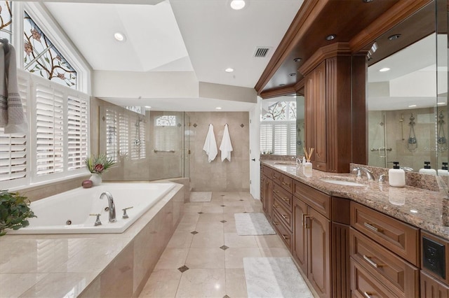 bathroom with a jetted tub, visible vents, a sink, and tiled shower