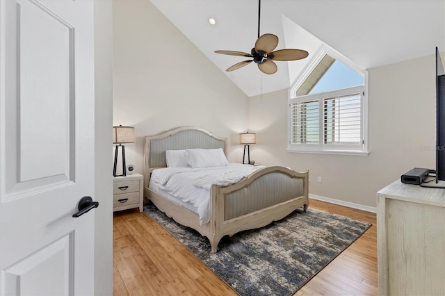 bedroom featuring a ceiling fan, baseboards, vaulted ceiling, and hardwood / wood-style floors