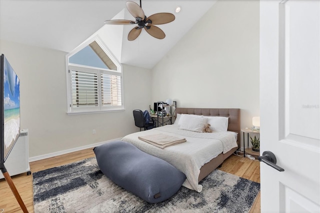 bedroom with a ceiling fan, vaulted ceiling, baseboards, and wood finished floors