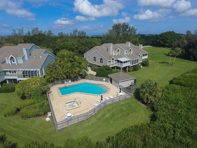 community pool with fence and a lawn