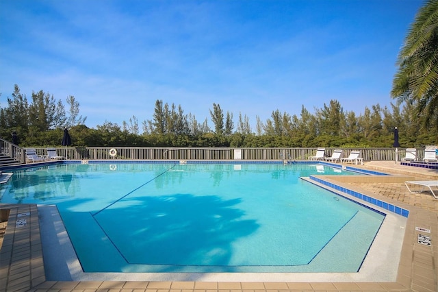 pool featuring a patio area and fence