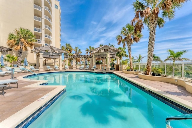 pool featuring a patio and fence