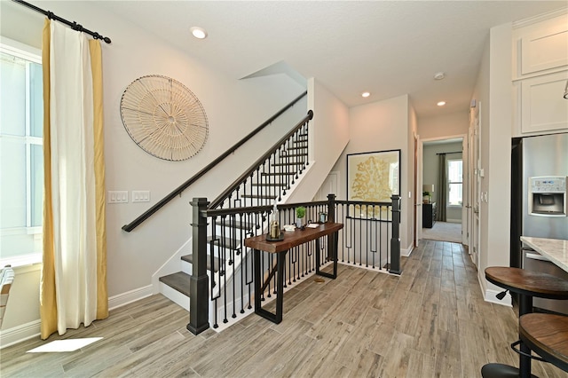 stairs featuring recessed lighting, baseboards, and wood finished floors