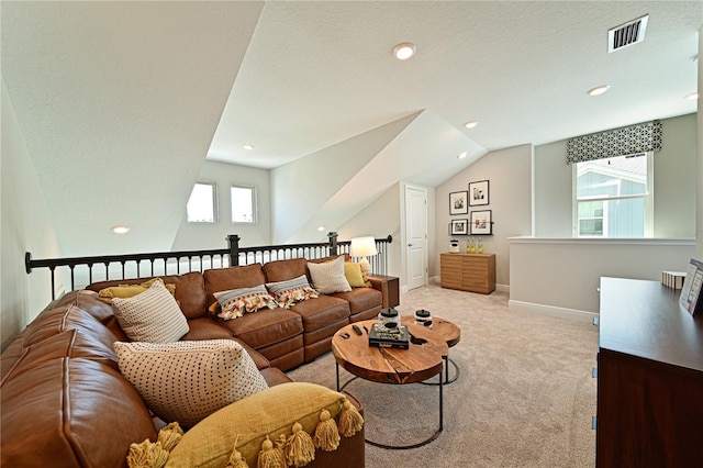 living room with light carpet, plenty of natural light, visible vents, and baseboards