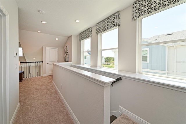 hallway featuring carpet floors, recessed lighting, vaulted ceiling, an upstairs landing, and baseboards